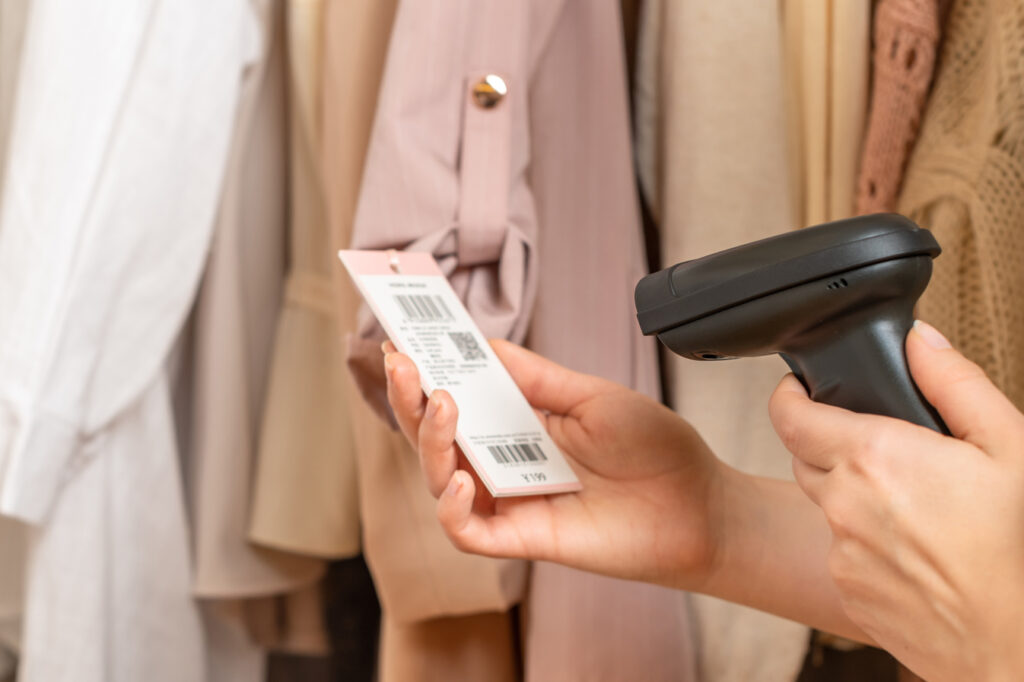 woman scanning barcode on retail clothing