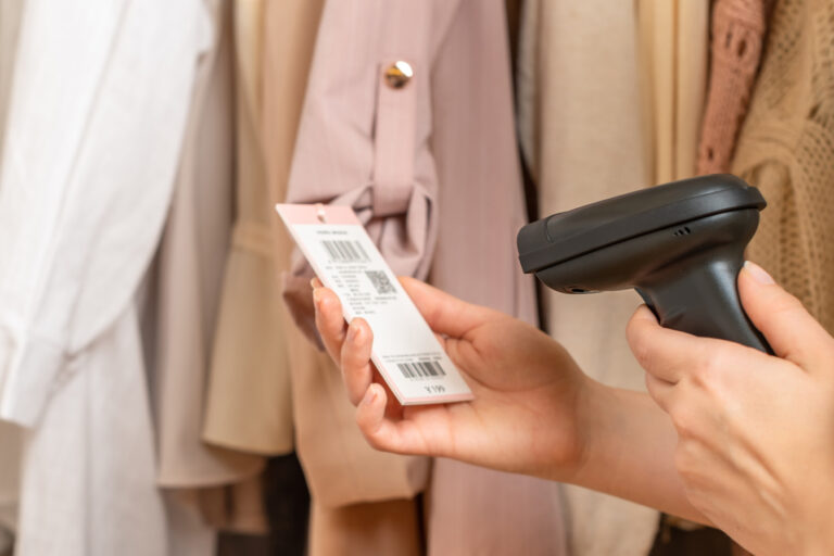 woman scanning barcode on retail clothing