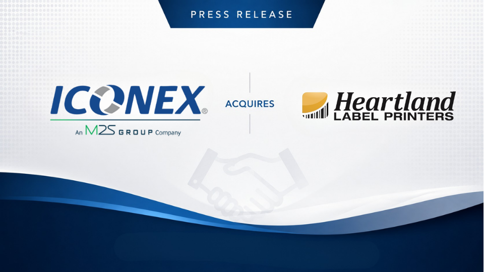 Press release banner showing ICONEX acquiring Heartland Label Printers with logos on a white to blue gradient background and a handshake watermark in the center